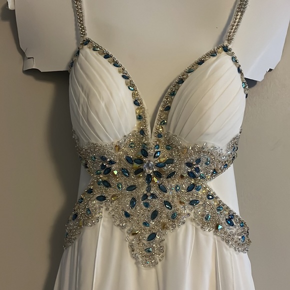 A Jasz Couture Beautiful white with blue florals formal dress with cut outs. - Picture 4 of 10
